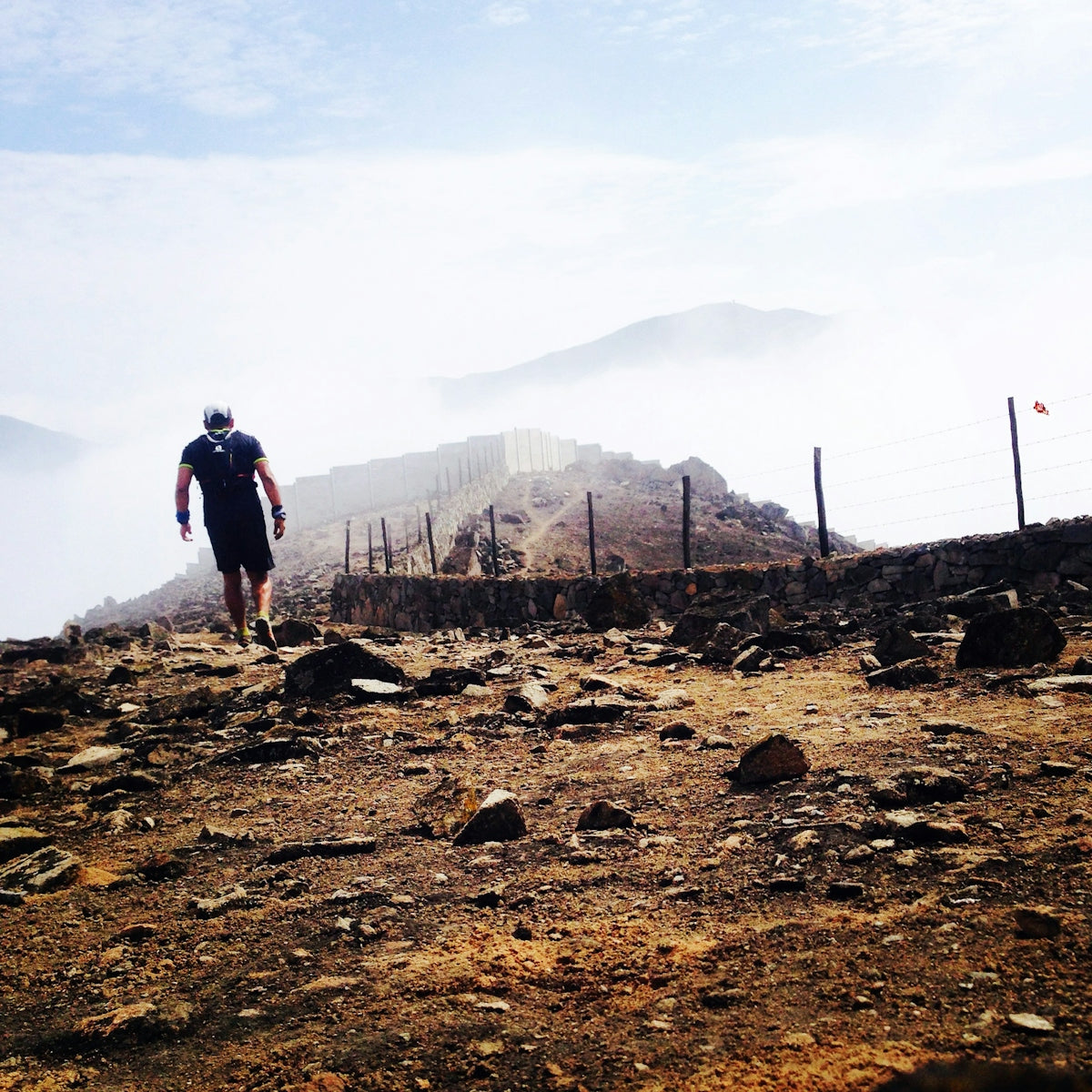 man walks on dirtroad
