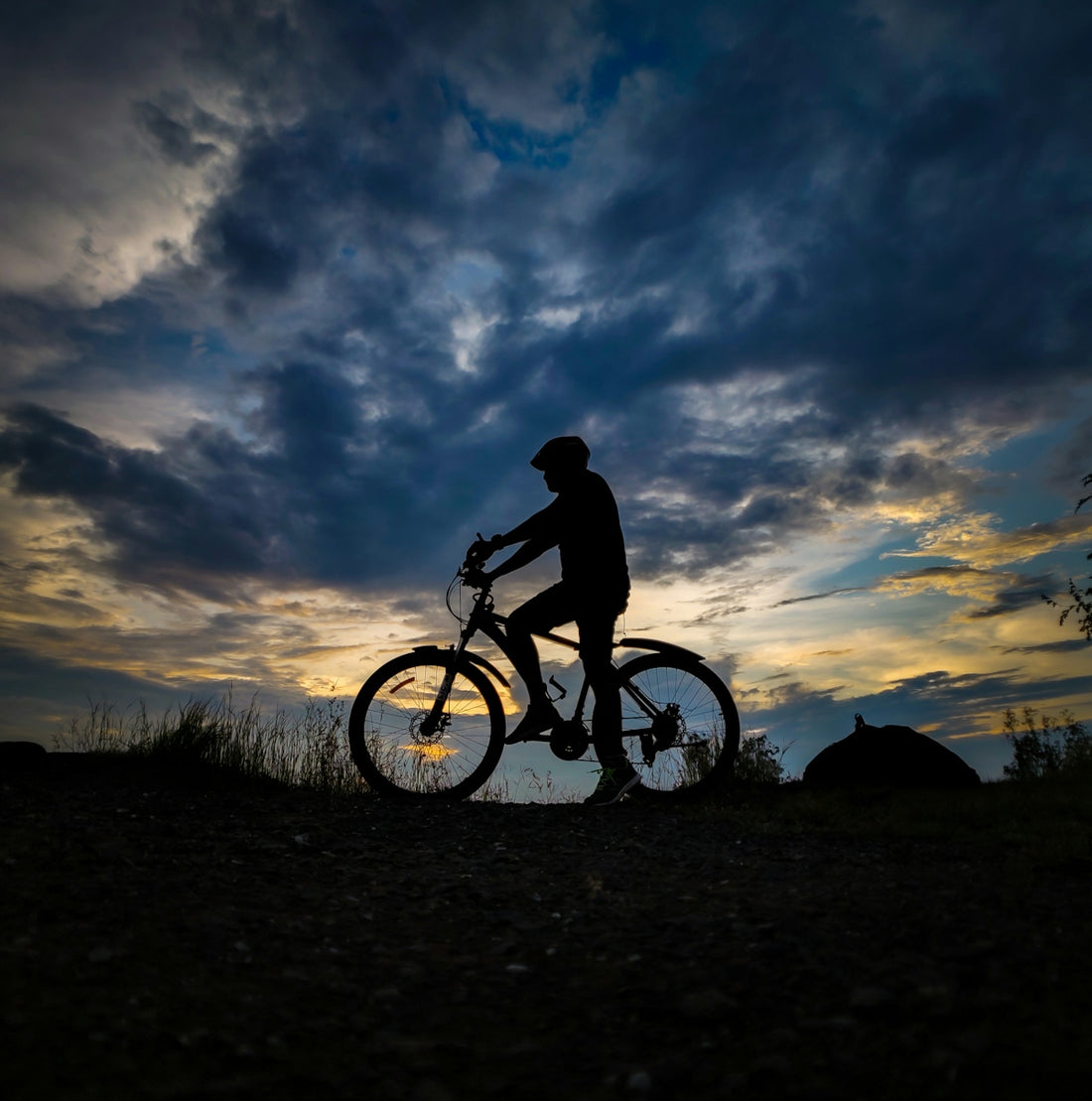 a person riding a bike on a dirt road