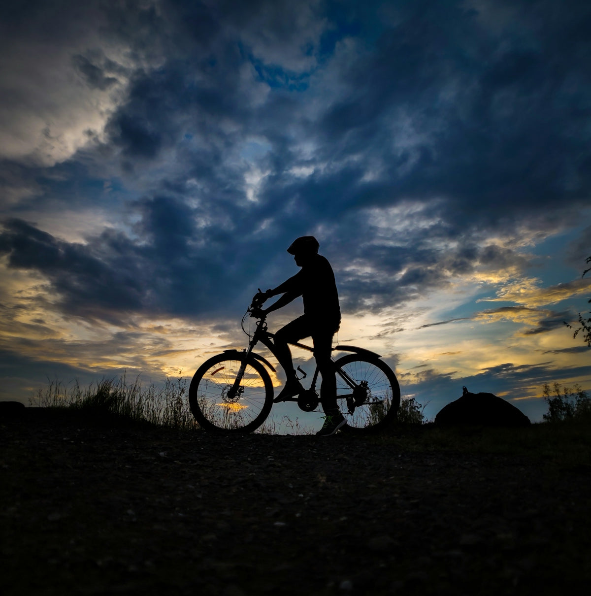 a person riding a bike on a dirt road