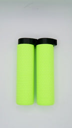 A pair of MTB Air Grips - Green Monstah! with knurled texture and black end caps are placed side by side on a plain white background.