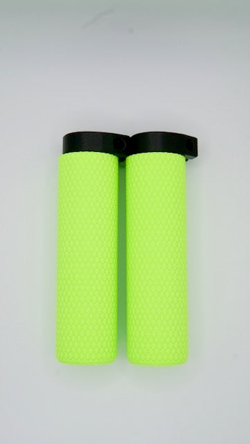 A pair of MTB Air Grips - Green Monstah! with knurled texture and black end caps are placed side by side on a plain white background.