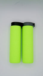 Two MTB Air Grips - Green Monstah! with a bright green textured design and black and gray clamps are placed side by side on a light background.