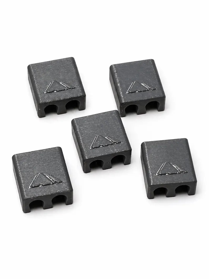 A pack of five black rectangular Brake and Shift Cable Clips with two holes at one end and a triangular symbol on top, displayed on a white background.